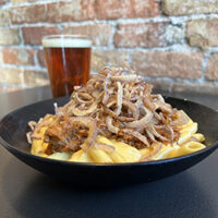 Kansas city Mac. Mac n Cheese topped with BBQ pork and crispy onions and a pint of Railhead Red